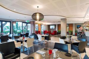 a dining room with tables and chairs in a restaurant at Rydges Kalgoorlie in Kalgoorlie