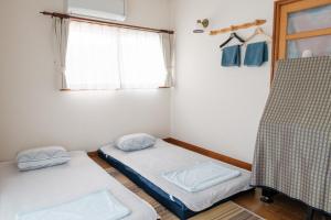 Postel nebo postele na pokoji v ubytování MaruHouse
