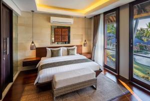 Voodi või voodid majutusasutuse Sundancer Residences and Villas Lombok toas