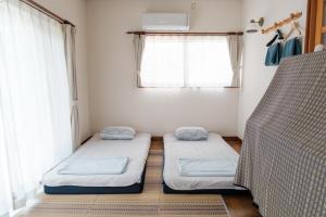 Postel nebo postele na pokoji v ubytování MaruHouse