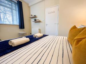 a bedroom with a bed with two towels on it at Wonderful Pavilion View 1BR by Sullivan Stays in Brighton & Hove