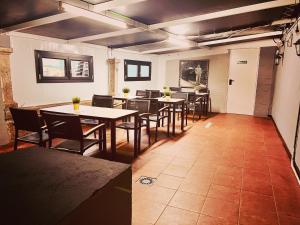 a restaurant with tables and chairs in a room at Alojamiento Camino Portugues in Porriño