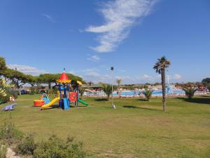 a park with a playground with a slide at Happy Camp Mobile Homes in Gitavillage California in Torre di Montalto