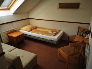 Ένα ή περισσότερα κρεβάτια σε δωμάτιο στο Penzion Ráj