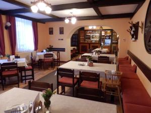 a dining room with tables and chairs in a restaurant at Penzion Ráj in Blíževedly