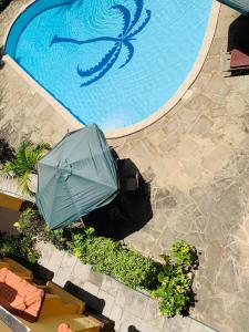 an overhead view of a swimming pool with an umbrella at Ltorec in Nyali