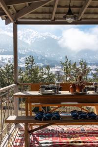 a table on a balcony with a view of a mountain at Mountain view close to Talgar Almaty in Kaynazarka