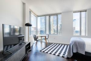 a bedroom with a bed and a table and chairs at Downtown Bellevue Studio w Gym WD nr shops SEA-117 in Bellevue