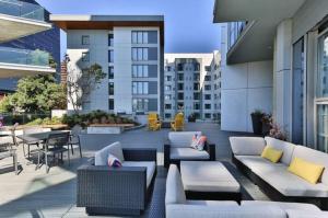 a patio with couches and tables and chairs on a building at Downtown Bellevue Studio w Gym WD nr shops SEA-117 in Bellevue