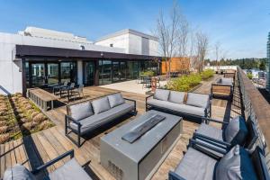 a patio with couches and tables on a building at Downtown Bellevue 1BR w Lounge Gyms nr shops SEA-125 in Bellevue