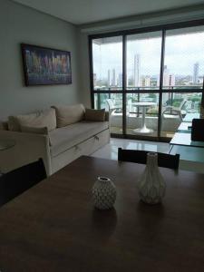 a living room with a couch and a table at Jardins da Madalena in Recife