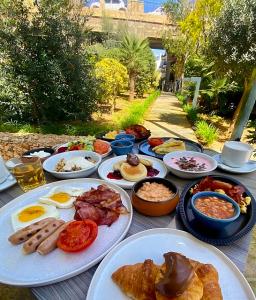 a table with plates of breakfast food on it at Maritim Antonine Hotel & Spa in Mellieħa