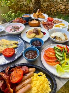 a table with many plates of food on it at Maritim Antonine Hotel & Spa in Mellieħa
