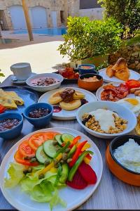 a table with plates of food and bowls of food at Maritim Antonine Hotel & Spa in Mellieħa
