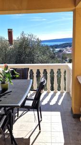 a patio with a table and chairs on a balcony at Apartments Ana & Ivan in Krk