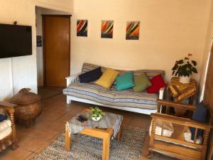 a living room with a couch with colorful pillows at Wild Aloe in Langebaan