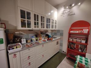  La cuisine est équipée de placards blancs et d'un réfrigérateur. dans l'établissement La Rosa di Orvieto, à Orvieto