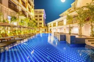 a swimming pool in the middle of a building at night at Angkor Land Urban Boutique in Siem Reap