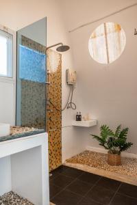 a shower with a glass door in a bathroom at Baan Koh Mak in Ko Mak