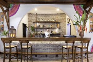 a bar with a person standing behind a brick wall at Serena Kim Boi Resort - Hoa Binh in Hòa Bình