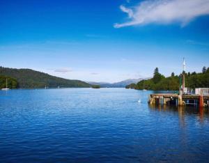 a large body of water with a dock on it at The Berry Boutique in Bowness-on-Windermere