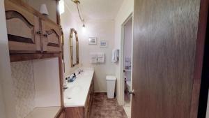 a white bathroom with a sink and a toilet at Claim Jumper 4 Townhouse With High Speed Wifi in Red River