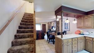 a kitchen with a staircase leading to a living room at Claim Jumper 4 Townhouse With High Speed Wifi in Red River