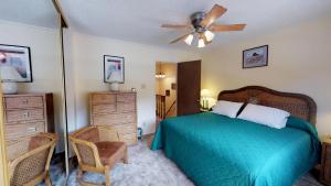 a bedroom with a bed and a ceiling fan at Claim Jumper 4 Townhouse With High Speed Wifi in Red River