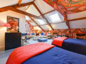 a bedroom with a ceiling covered in colorful wallpaper at Pigwigs Place in Cornwood