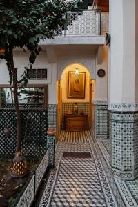 a hallway of a building with a tree at Riad 4 jardins in Marrakesh