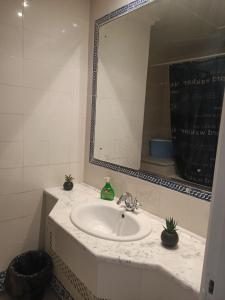 a bathroom with a sink and a mirror at EL MANZEl 102 in Houmt Souk