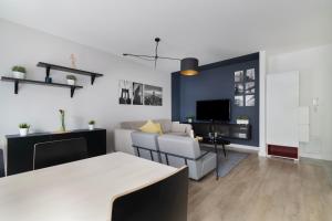 a living room with a couch and a table at EASY RENT Apartments - GUSTO in Lublin