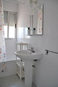 a white bathroom with a sink and a shower at villa beltran in Vinarós