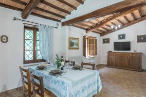 een eetkamer met een tafel en een televisie bij Casina del Bosco in Santo