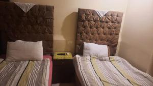 two beds sitting next to each other in a room at My place agata Hostel in Cairo