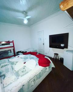 - une chambre avec un lit et une télévision à écran plat dans l'établissement Casa da Praia, à Santos