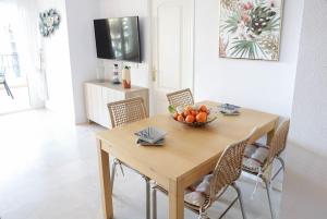 a dining room table with a bowl of fruit on it at Bahía Relax Puerto de Sóller in Port de Soller