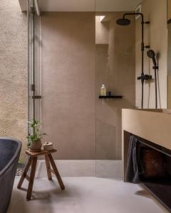 a bathroom with a shower and a fireplace at Maana Kiyomizu in Gionmachi