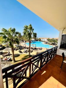 a view of the pool from the balcony of a resort at Spacious Apartment @MeliaTortugaResort in Prainha