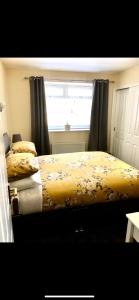 two twin beds in a bedroom with a window at Carnegie Lodge Hotel in Tain