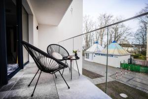 a chair on a balcony with a view of a building at Cristal Baltic in Ustka
