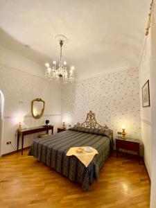 a bedroom with a bed and a chandelier at Hotel Martelli in Florence