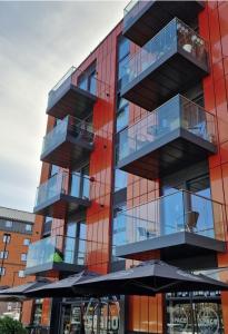 a building with balconies on the side of it at Luxury 1 Bedroom Waterside Apartment in Gloucester Docks in Gloucester
