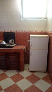 a small kitchen with a refrigerator and a counter at DAKHLA in Dakhla