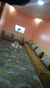 a living room with a couch and a tv at DAKHLA in Dakhla