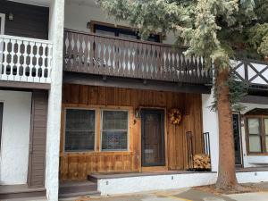 a house with a wooden porch and a balcony at Claim Jumper 9 Townhouse With High Speed Wifi in Red River