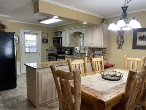 a kitchen with a wooden table and a dining room at Claim Jumper 9 Townhouse With High Speed Wifi in Red River