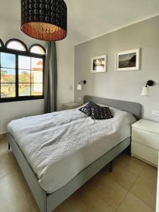 a bedroom with a bed and two windows at Casa Hugo in Costa Calma