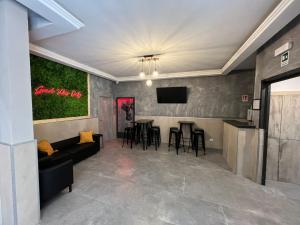 a living room with a couch and a bar at Palladini Hostel Rome in Rome