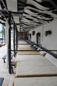 a row of beds lined up in a room at La Vella Resort in Dubova